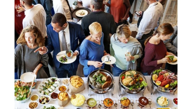 Adults enjoy a holiday buffet.